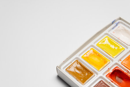 A set of used bright watercolor paints on a white background. Close-up macroの写真素材