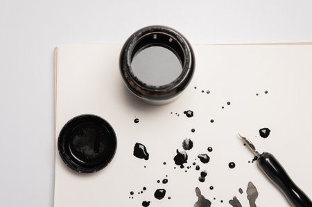 Stylish fountain pen and inkwell on paper with ink stains, flat lay. Abstract ink background set, grunge art. Black paint stroke texture on white paper. Wallpaperの写真素材