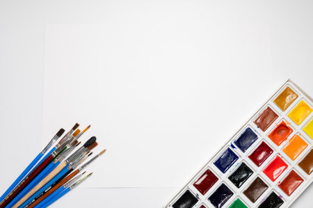 A set of watercolor paints and brushes on a white background with copy space. Design background art and paintingの写真素材