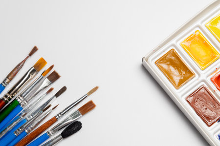 A set of watercolor paints and brushes on a white background with copy space. Design background art and paintingの写真素材