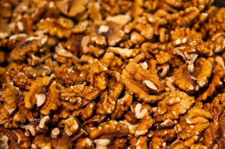 Raw, shelled walnuts, many nuts in the background. Bright brown, broken walnuts, freshly harvestedの写真素材