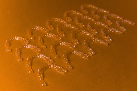 Dental background: many clear braces and aligners lie textured on a colored background. Dental...