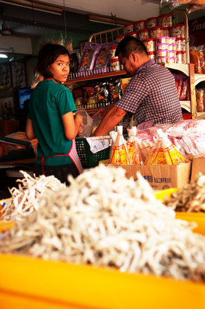 Pasir Penambang,Malaysia  April 18 2015 : Young lady working on fish marketのeditorial素材