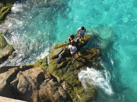People standing on a rockの素材