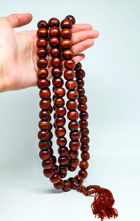 hand holds chinese large bead rosaryの写真素材