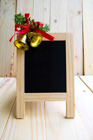Blackboard sign with Christmas bells decorationの写真素材