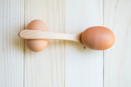Eggs and wooden spoonの写真素材