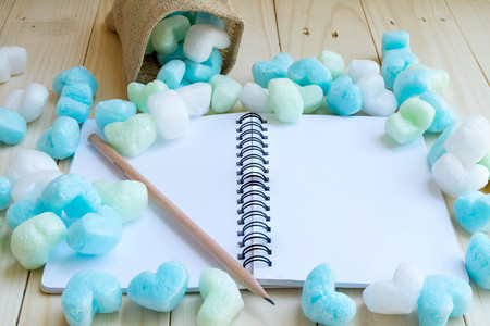 Blue green hearts and blank notebook in soft tone