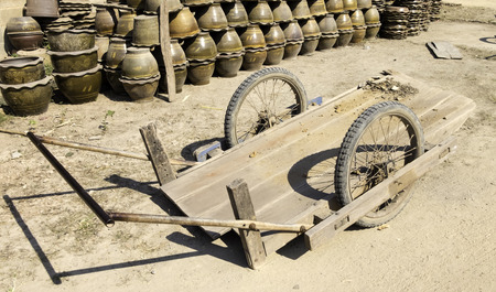 Dirty wooden cart uses to carry crockery or flower pots.の写真素材