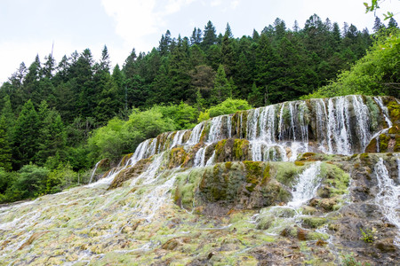 Marvelous flying waterfall during summer season in Huanglong national park.の写真素材