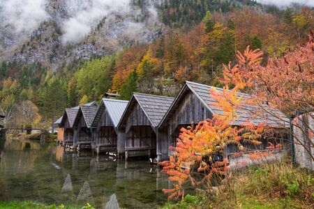 Oct 22, 2017 - Obertraun, Austria: Personal boathouses in Obertraun town during autumn season with colorful leaf and fog.のeditorial素材