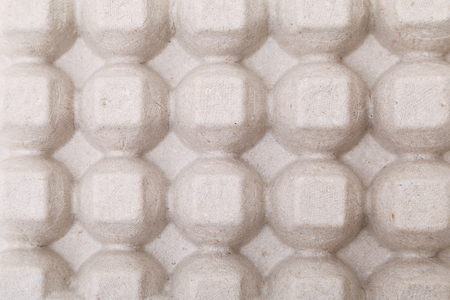 Paper container for quail eggs, close-up texture background.