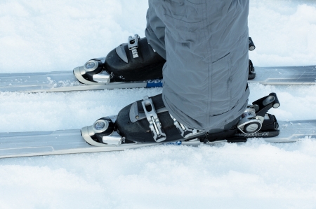 Ski boots and skis in the snowの写真素材