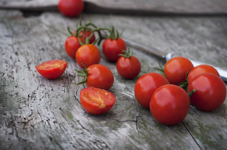 Fresh red cherry tomatoes on a wooden backgroundの写真素材