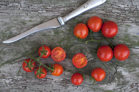 Fresh red cherry tomatoes on a wooden backgroundの写真素材
