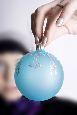 The Christmas and new-year dress is in a woman's handの写真素材