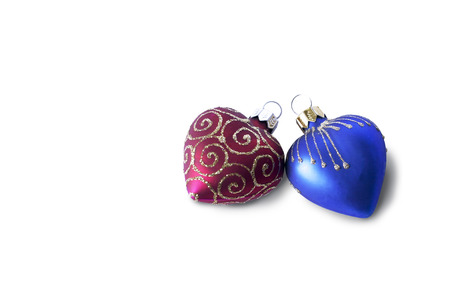 The Christmas and new-year decoration in the form of heart. Red and blue hearts on white backgroundの写真素材