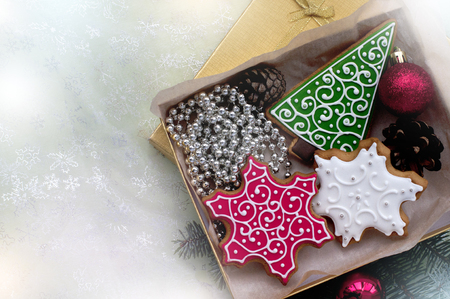 Christmas gingerbreads in the form of a fir-tree and snowflakes in a boxの写真素材