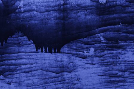 Blue abstract background with flowing paintの写真素材