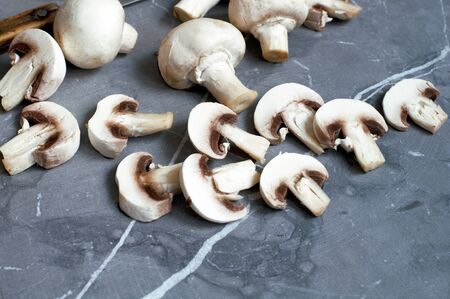 Sliced mushrooms champagne and knife on grayの写真素材