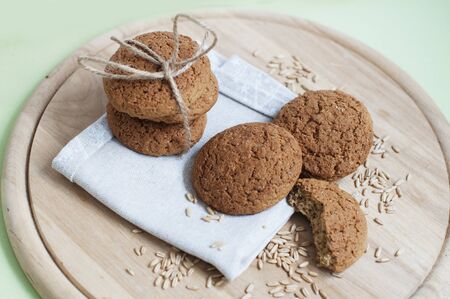 Oat cookies with oat grains on a wooden board.の写真素材