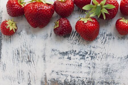 Strawberries on white wooden background. Top viewの写真素材