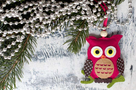 New Year and Christmas card with owl, fir branches and christmas decorations on a white wooden background. A postcard with Christmas decorations.の写真素材