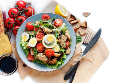 Salad with mussels, tomatoes, eggs, arugula, spinach, lemon and croutons on blue background. Seafood salad with vine sauce. Top viewの写真素材