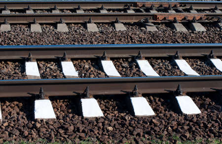 Railway with rails and sleepers parallel. Gray and white stripesの写真素材