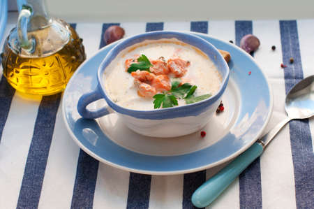 Creamy salmon soup Kalakeitto with salmon, carrot, parsley, onion, garlic, potatoes, croutons and spoon on white background. Traditional Finnish hot soupの写真素材