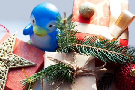 Christmas decoration with gift box and toy penguin on white background.の写真素材