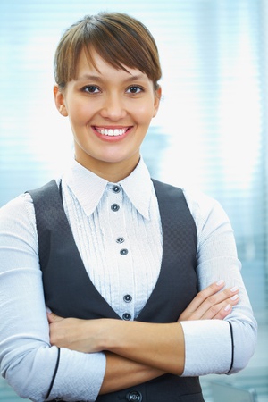 portrait of a young businesswoman smiling against the office background の写真素材