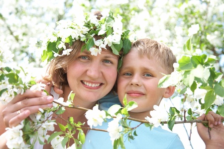 Portrait of Beautiful Happy mother with her son in the spring gardenの写真素材