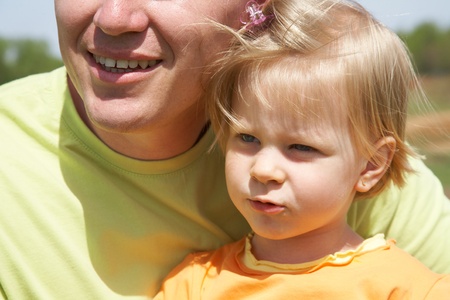 closeup portrait of father and little daughter outdoor の写真素材