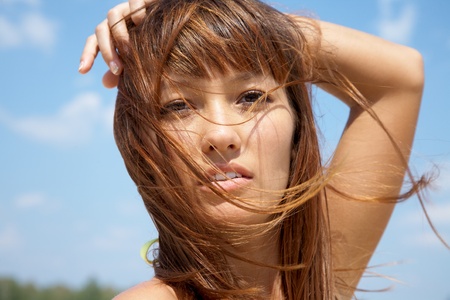 portrait of beautiful young girls in bikinis with flowing hairの写真素材