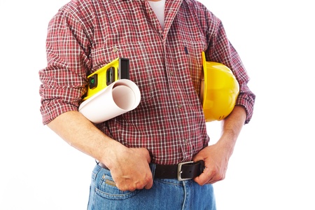 Close-up unrecognizable builder with the tools and a helmet under his arm の写真素材