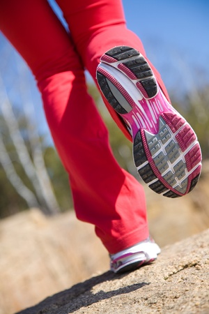 Close-up legs of a girl jogging on the woodの写真素材