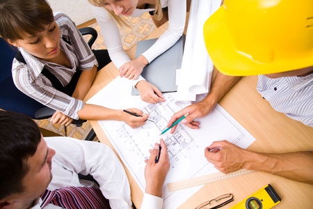 Meeting the team of engineers working on a construction project at the table. Up viewの写真素材