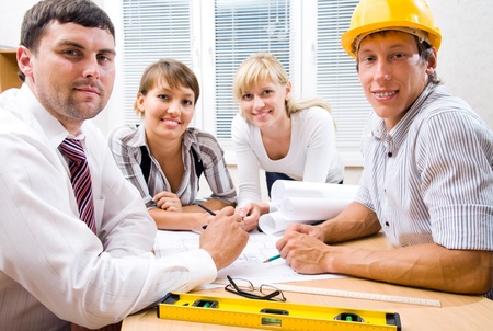 Portrait  the team of engineers working on construction project at the tableの写真素材