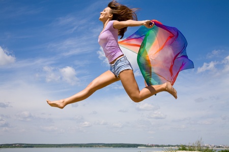 Beautiful young Woman enjoy and jumping on the beach の写真素材