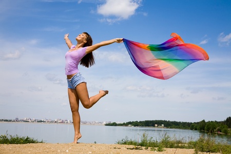 Beautiful young Woman enjoy and jumping on the beachの写真素材
