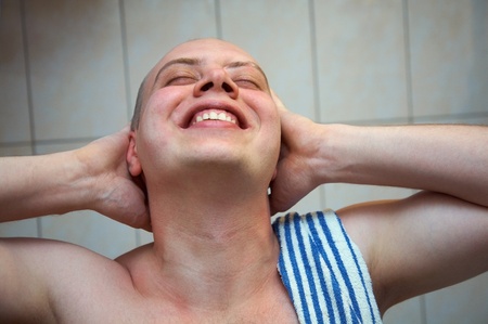 happy man with his eyes closed in the bathroomの写真素材