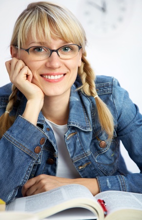 portrait of Intelligence girl student reading  book in classroomの写真素材