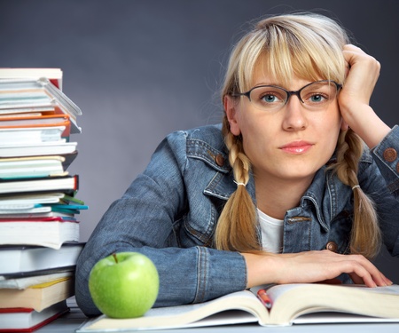 portrait of tiredness girl student reading  book in classroomの写真素材