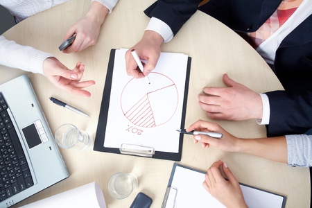 young businesswoman drawing graph on chart in officeの写真素材