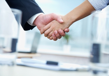 Clouse-up of businessman and  businesswoman shaking handsの写真素材