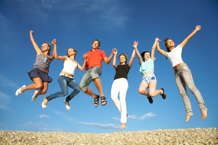 group of happy young people dancing at the beach on  beautiful summer dayの写真素材