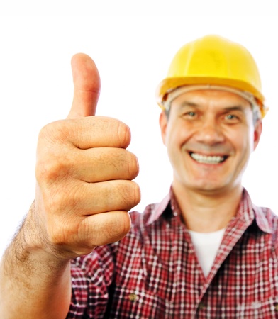 handsome man builder smiles and shows OK gesture with both handsの写真素材