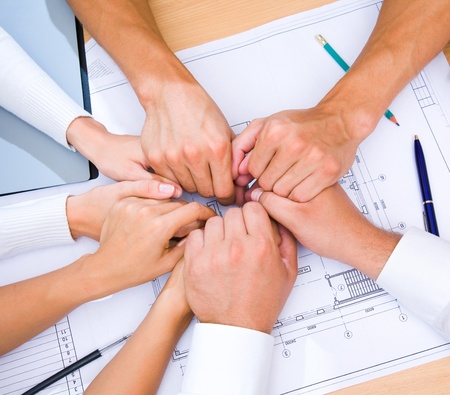 picture of hands to stay together over the table to show solidarity teamの写真素材