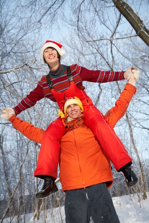 The young family plays winter wood on snow in Valentineの写真素材